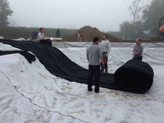 Pond liners being installed above a Geotextile protect underlay